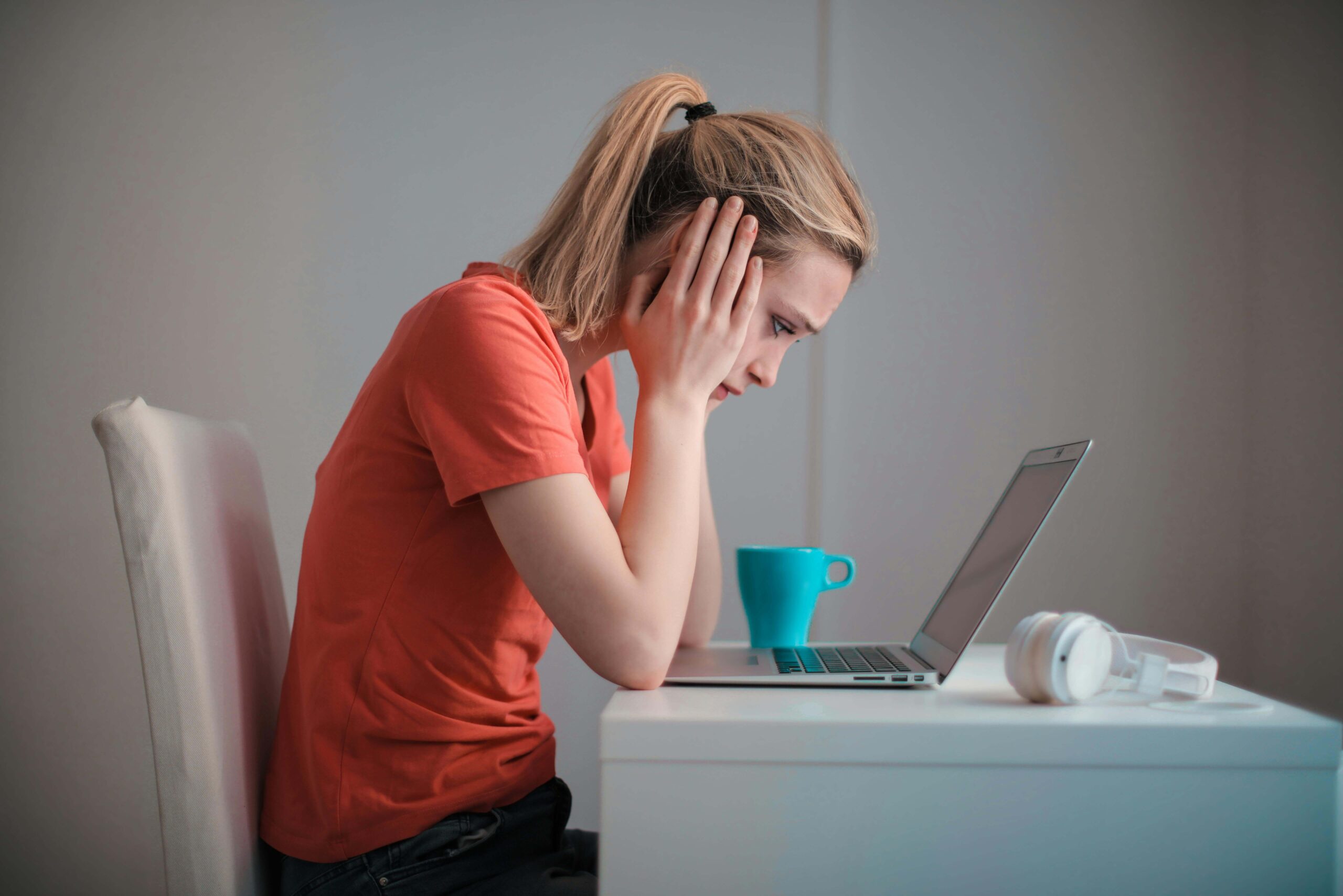 Young, worried woman looking at a laptop